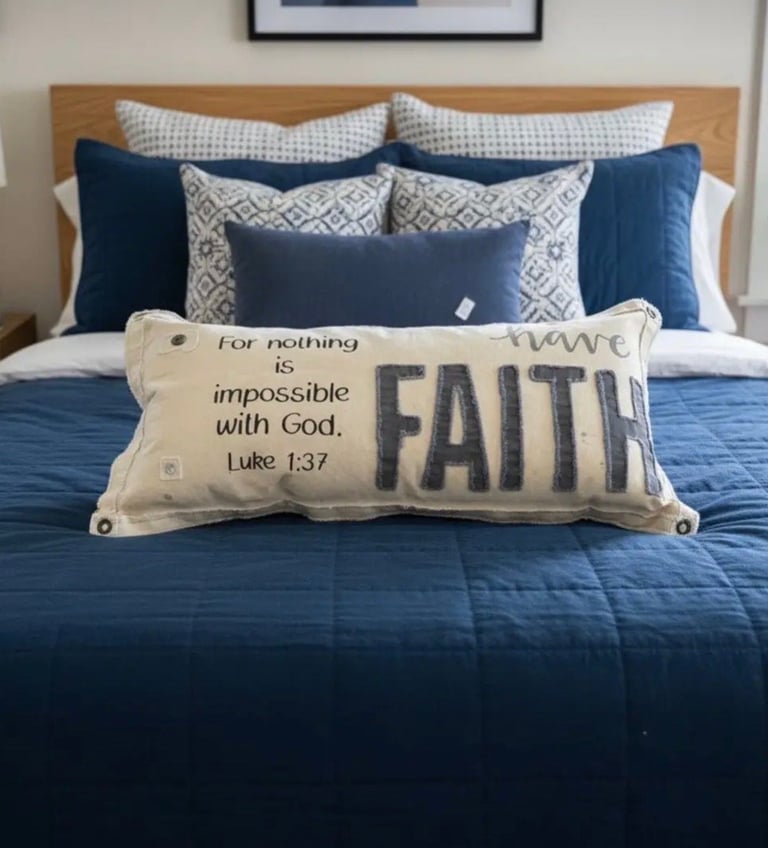 Bedroom with blue and white bedding and decorative pillows, featuring a cream throw pillow with Faith and Luke 1:37 scripture quote