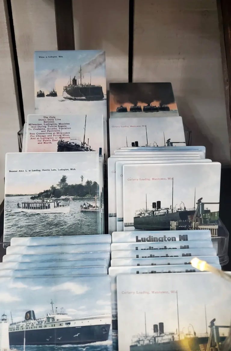 Collection of vintage postcards and photographs of ships and steamboats stacked and arranged on a surface